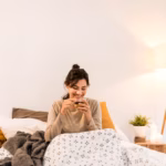 young-woman-drinking-her-tea-bed_23-2148821659